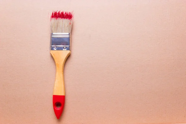 Construction brush with red paint — Stock Photo, Image