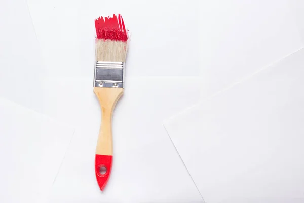 Construction brush with red paint — Stock Photo, Image