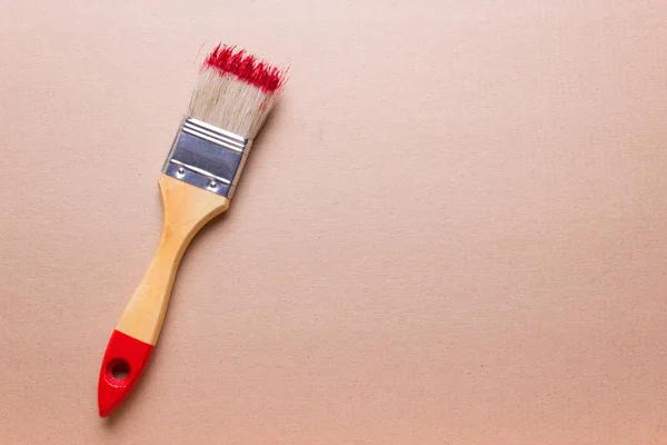 Construction brush with red paint — Stock Photo, Image
