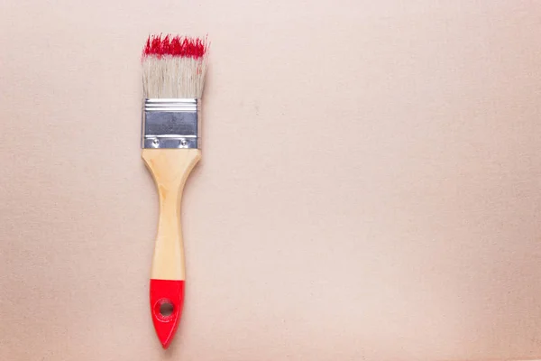 Construction brush with red paint — Stock Photo, Image