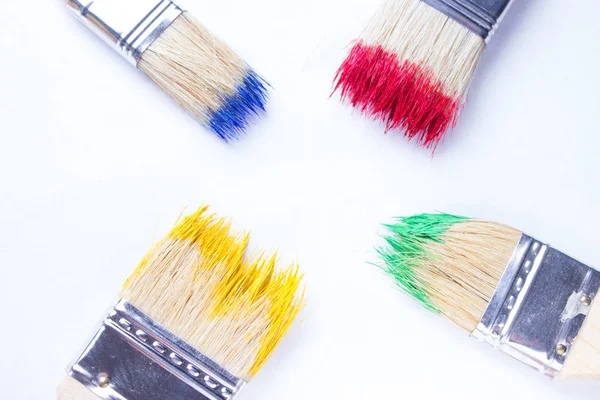 Paintbrushes in colorful paint — Stock Photo, Image