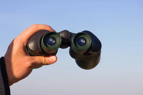 Binocular in mans hands — Stock Photo, Image