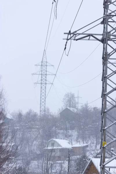 Energy and technology: electrical post by the road with power line cables,