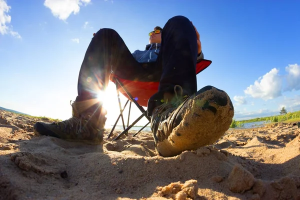 very self confident and arrogant men sit on the beach