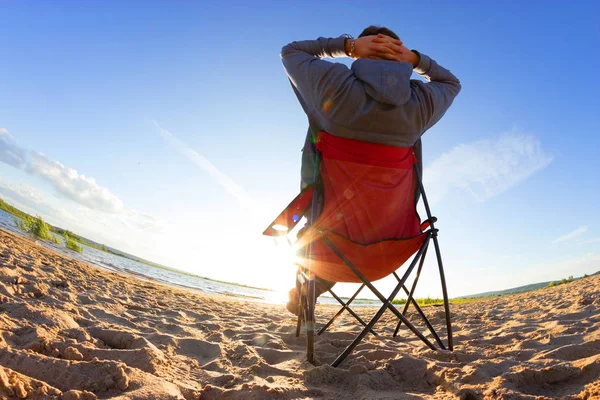 man relax on beach chair in sunny day