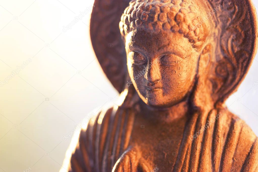 bronze colored buddha statuette