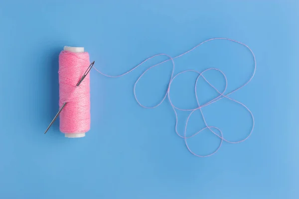 pink thread and needle