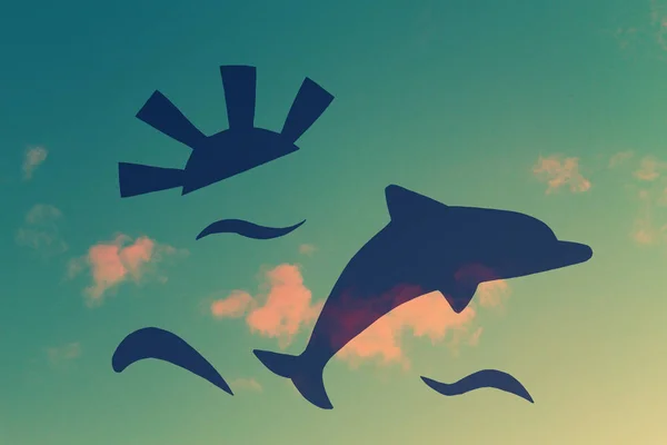 Dolphin silhouette on sunset sky background — Stock Photo, Image