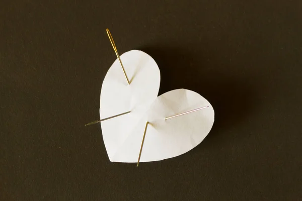 Paper heart with needles