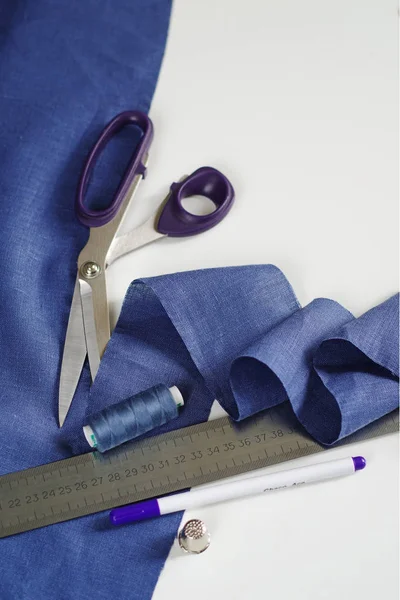 Textilien messen und schneiden. Schere und violettes Leinengewebe. — Stockfoto