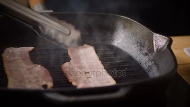 Cooking hamburger. Two pieces of smoked ham are being turned over and fried in a broiler pan for burger. 4K — Stock Footage Cooking hamburger. Two pieces of smoked ham are being turned over and fried in a broiler pan for burger. 4K Video Clip