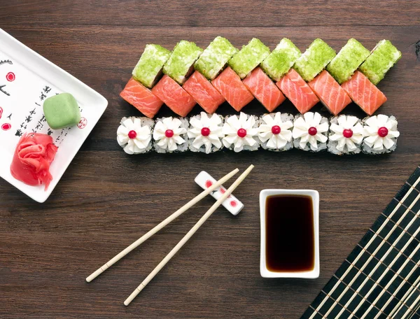 Sushi set with ginger and wasabi on wooden background — Stock Photo, Image