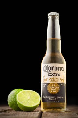 Corona bira üzerinde ahşap masa üstünde siyah izole limonlu editoryal fotoğraf. Kopya alanı