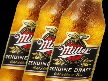 Editorial photo of close-up Miller Genue Draft Beer bottles isolated on black. clipart