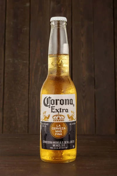 MINSK, BELARUS - JUNHO 29, 2017: Foto editorial de garrafa de cerveja Corona Extra sobre fundo de madeira, uma das cervejas mais vendidas em todo o mundo é uma cerveja pálida produzida pela Cerveceria Modelo no México — Fotografia de Stock
