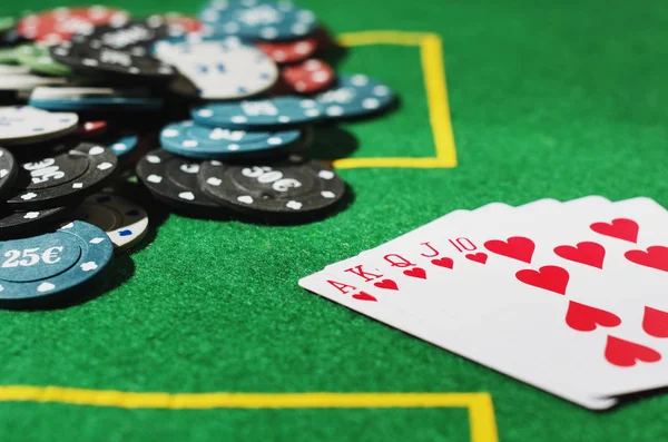 poker cards with chips on green table