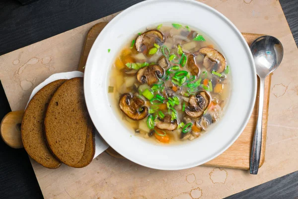 Delicious soup in bowl with mushroom and greens — Stock Photo, Image