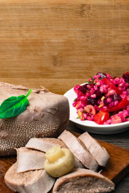 Kiraz domates, sığır eti veya domuz eti diliyle haşlanmış pancar, mantar - champignon, fesleğen yaprağı, atış, stüdyo ahşap arka plan üzerinde izole. Üstten Görünüm