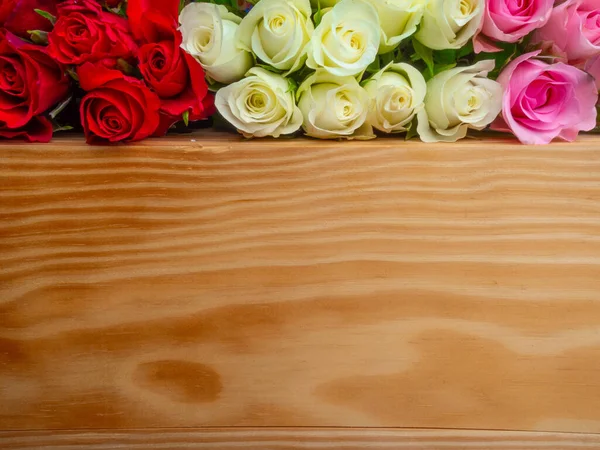 Egy csomó nyitott rózsa különböző színekben fa felületen, szelektív fókusz — Stock Fotó