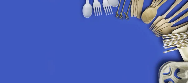 Eco-friendly biodegradable cutlery, Ecological disposable tableware for food on a trendy blue color background