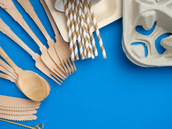 Eco-friendly biodegradable cutlery, Ecological disposable tableware for food on a trendy blue color background