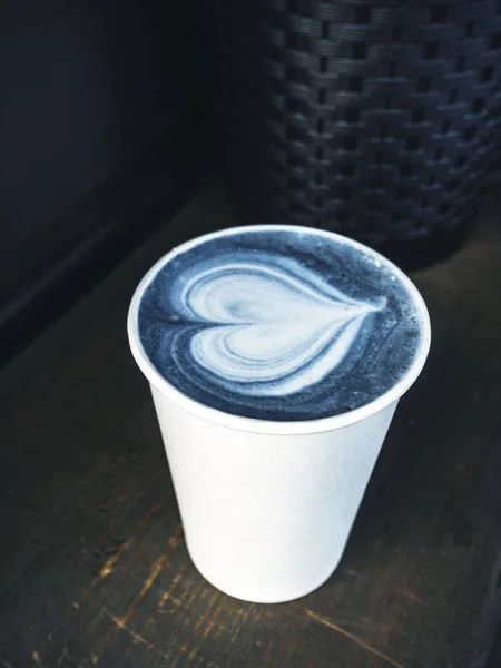 Trendy blue color matcha on wooden rustic background with beautiful latte art, stylish toning — Stock Photo, Image