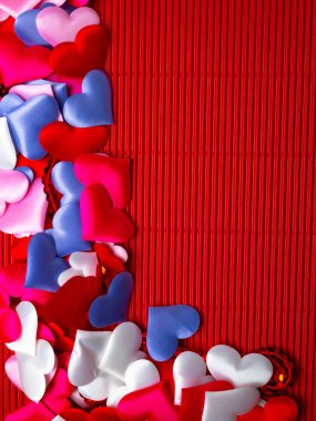 greeting card with a colorful hearts and space for text on a red background. Valentine, wedding decorations. Various hearts