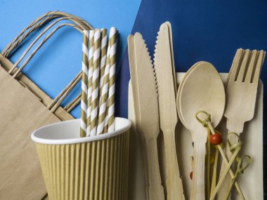 Moda mavisi arka plan, çatal bıçak, geri dönüşüm ve çevre dostu kavram üzerine tek kullanımlık ahşap çatal bıçak ve kağıt çanta, plastiksiz alternatifler sıfır atık çevre koruması