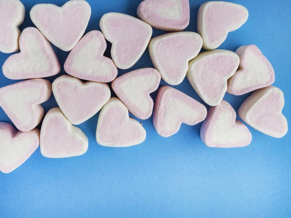 marshmallow snack in heart shape. Decorate design Love on trendy classic blue background. Heart symbol. Valentine\'s day concept.