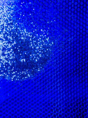 2020 color trend. Festive background of blue color glitter on trendy blue surface.