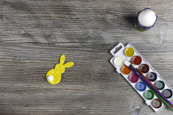 preparing for easter holidays, easter egg paints, brushes, bunny and egg