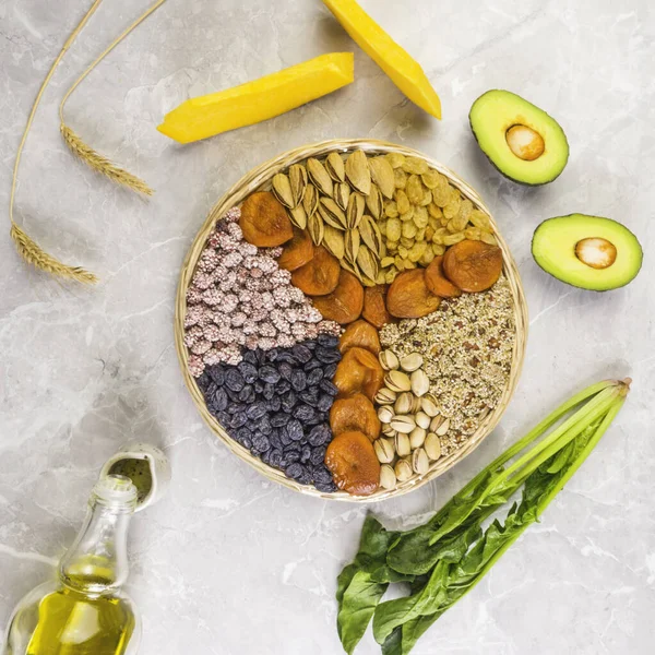 Food sources of vitamin E, high in antioxidants, anthocyanins, minerals and fiber, The concept of healthy food for brain and heart on concrete background, top view, flat lay