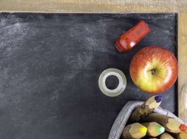 Elmalı okul hayatı, kara tahtada renkli kalemler.