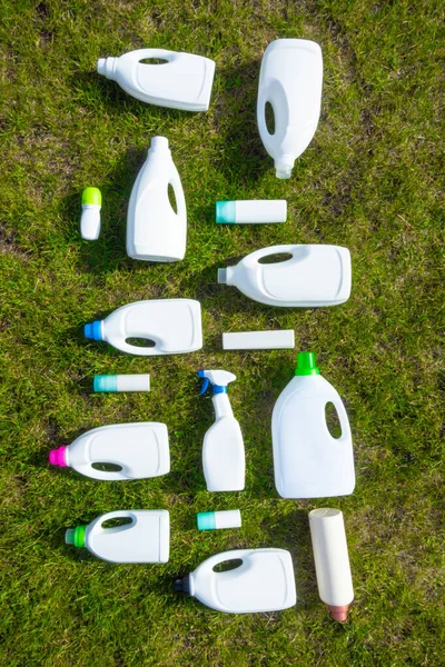 plastic bottles from chemistry on green grass, ecological and stop plastic concept