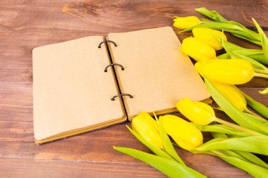 Açık vintage defter ya da günlüğü ve Sarı laleler