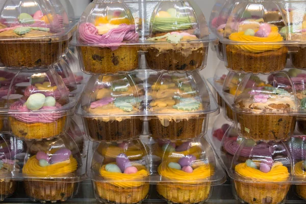 Sweet cakes in plastic package with sweet eggs in nest for easte