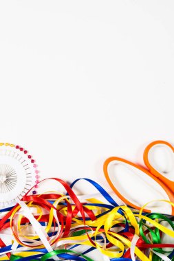 Makas, iğne ve yeşil arka plan üzerinde renkli bantlar