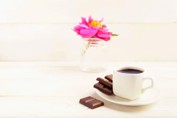 Una taza de café con chocolate y una flor en jarrón sobre fondo blanco —  Fotos de Stock