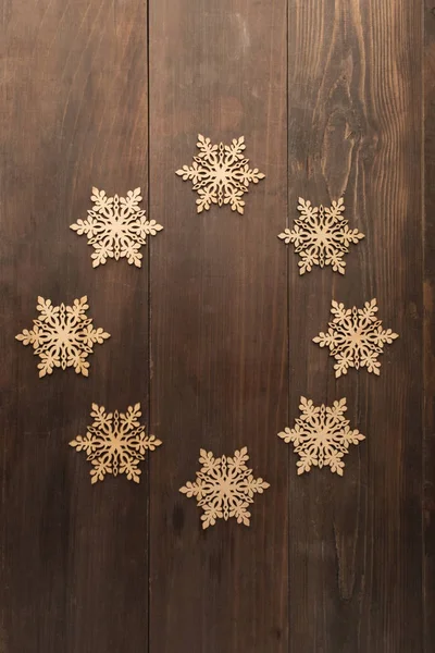 Circle wooden snowflake frame design on wooden table — Stock Photo, Image