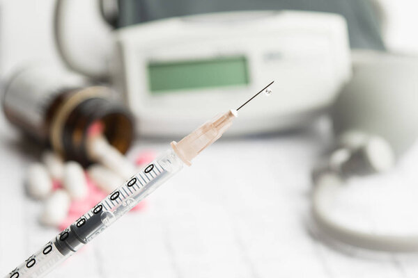 Drop on syringe needle for blood pressure concept