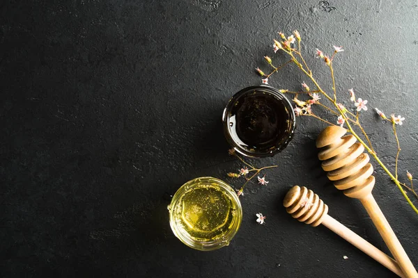 Two type of healthy organic honey with two wooden spoons