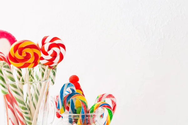 Различные красочные конфеты. Смешайте конфеты в банках на белом деревянном фоне с копировальным пространством — стоковое фото