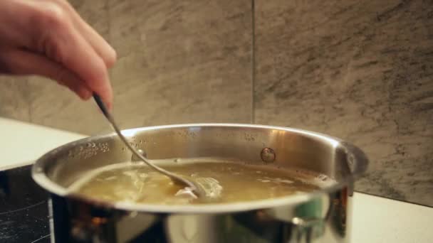 Woman Hand Stirs Pasta Pan Spoon Home Kitchen Selective Focus — Stock Video