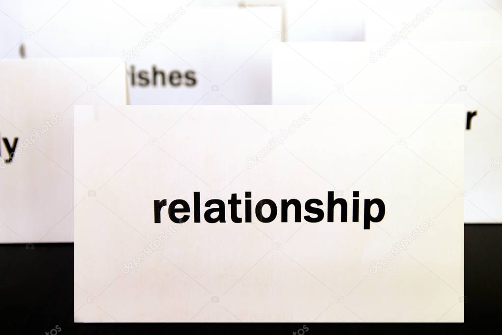 Word Relationship on a white paper card surrounded by other words.  Priorities and values concept