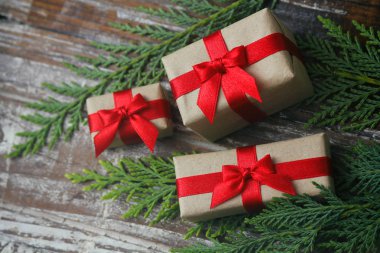 Bazı hediye kutuları kahverengi zanaat kağıt sarılmış ve kravat kırmızı saden kurdele. Dekoratif ahşap arka plan. Metin alanınız. Hediyeler seti.