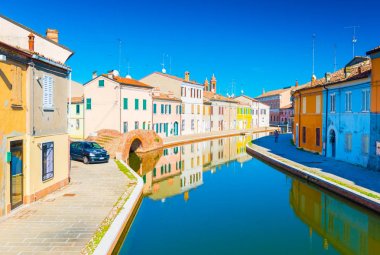 Comacchio - October 2016, Emilia Romagna, Italy: View of the canal with bridge and  colored houses reflected in the water. Italian town of Comacchio also known as the 