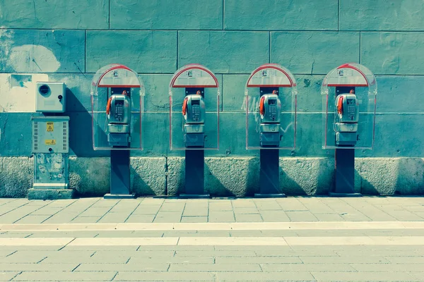 Four phone booths by the wall