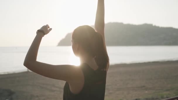 Girl doing hand stretching at sunset. Slow motion. — Stok video