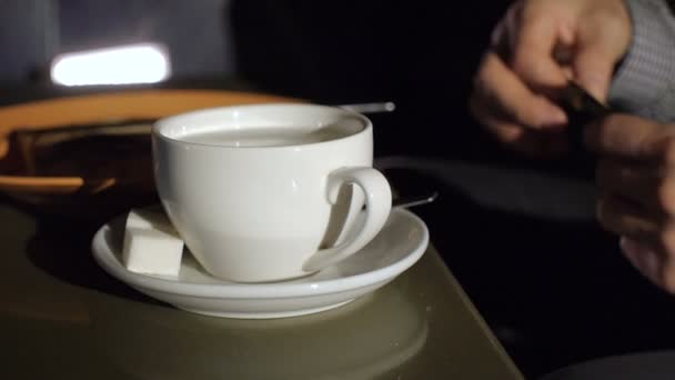 Young man stirring tea with spoon — Stock Video