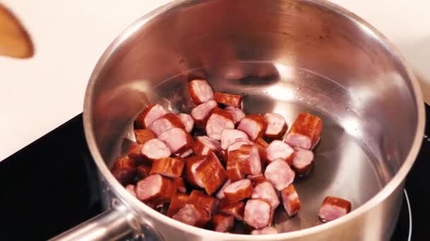 A close-up of sliced sausages from a bowl. — Stock Video